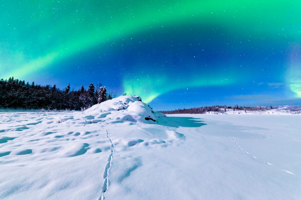 a remote area with the northern lights in the background
